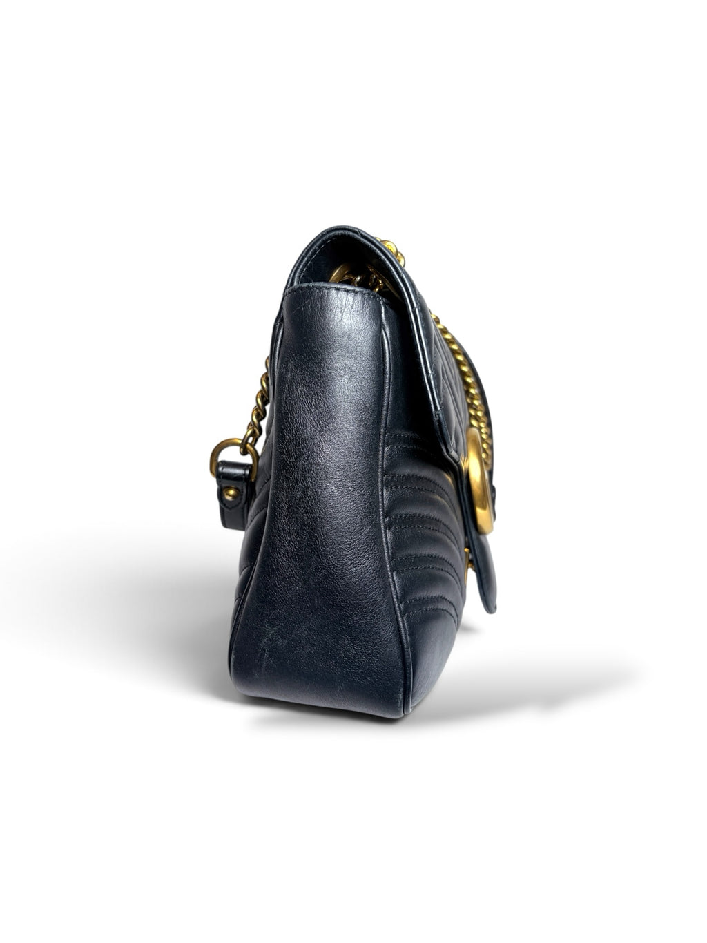 Side view of a Thrift Mint Gucci Marmont black quilted leather shoulder bag with antique gold chain strap