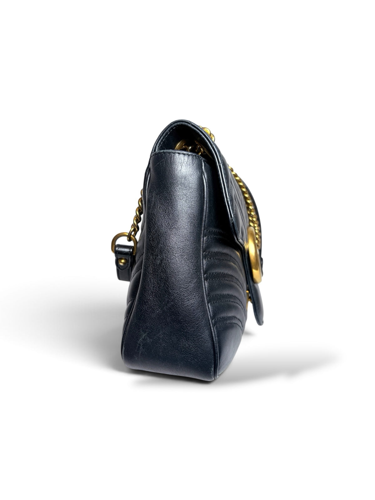 Side view of a Thrift Mint Gucci Marmont black quilted leather shoulder bag with antique gold chain strap