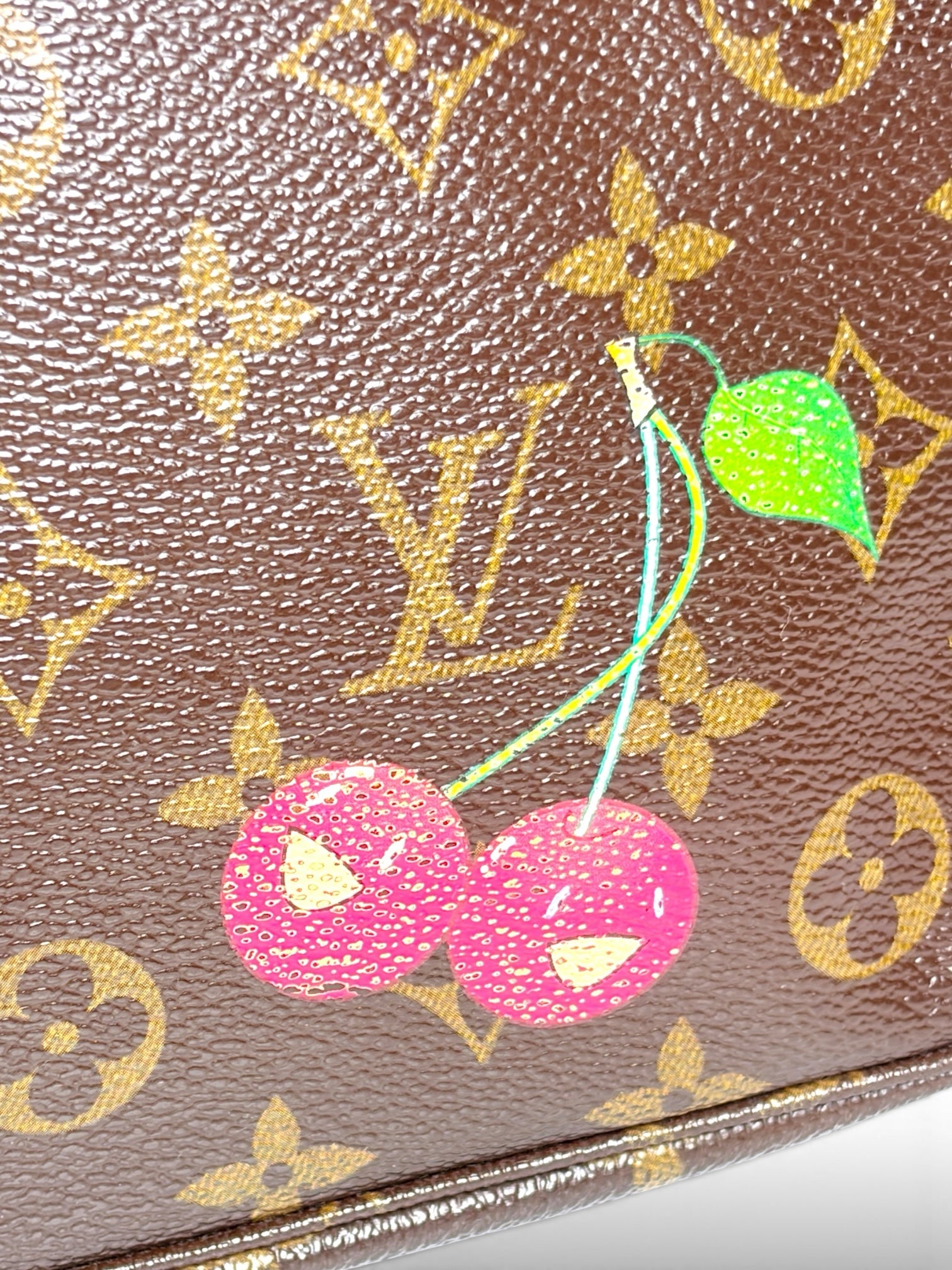Thrift Mint Louis Vuitton Monogram canvas with playful cherry motif and iconic gold LV logo pattern